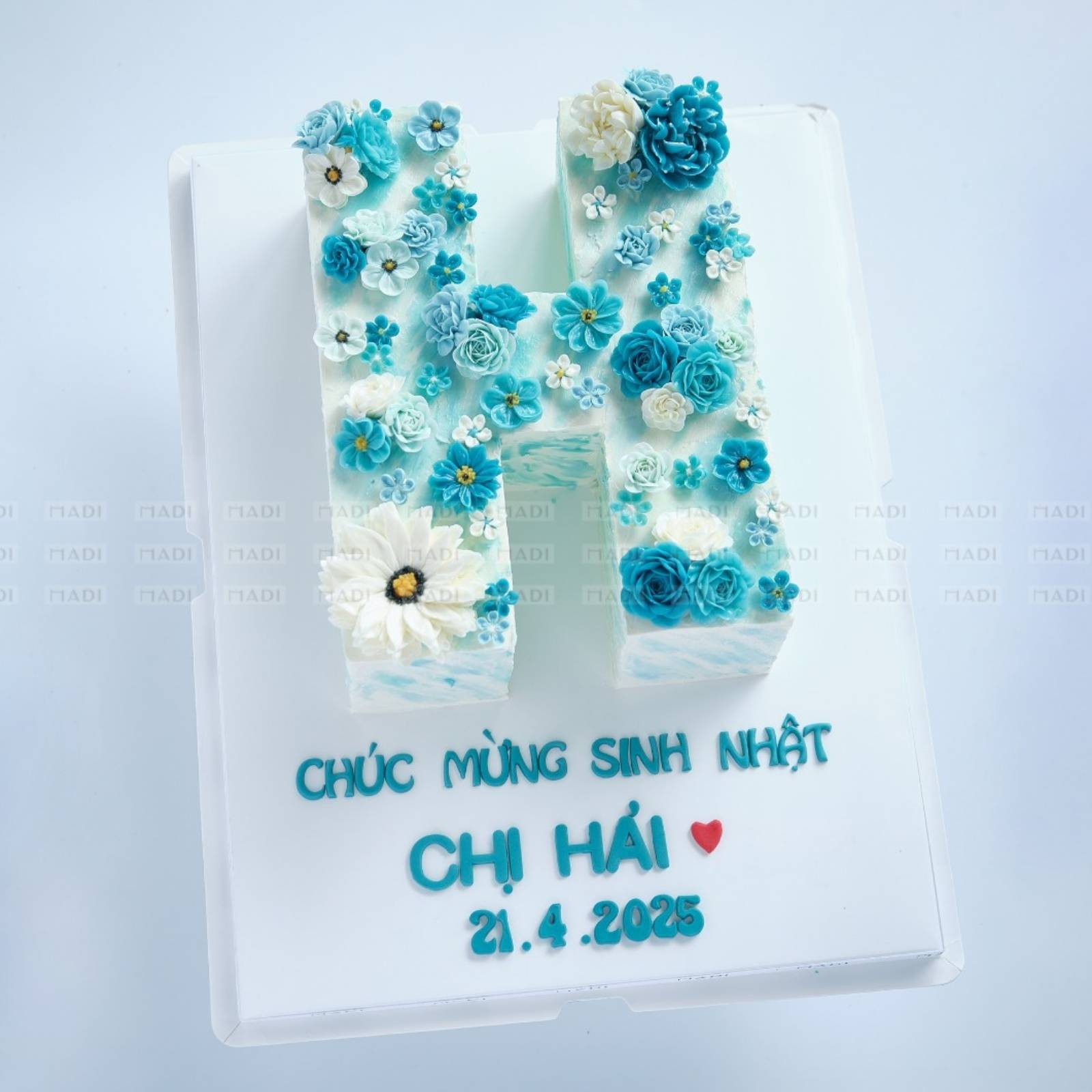 Bánh kem tặng khách hàng với thiết kế chữ cái từ hoa kem bơ ngọt ngào, phù hợp gửi tặng dịp sinh nhật